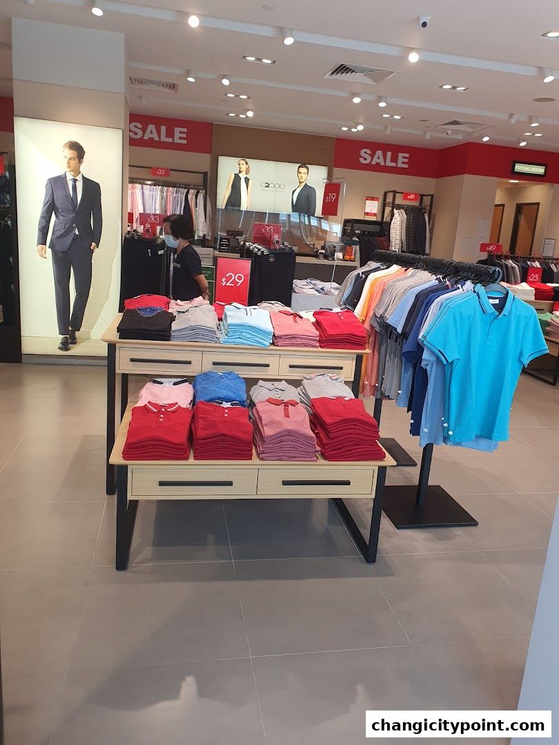 Interior of a G2000 clothing store with sale signs and folded shirts.