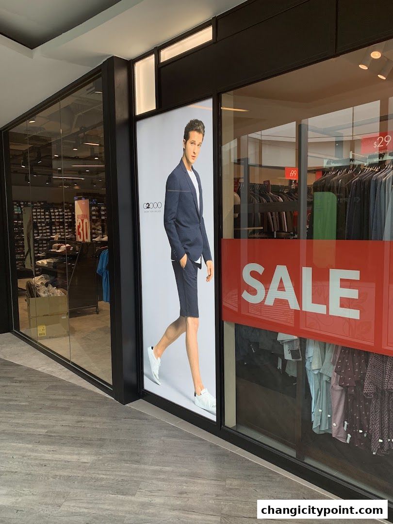 G2000 shop front with a model and a large SALE banner.