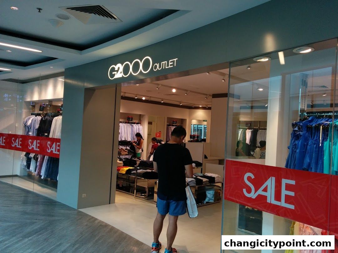 G2000 Outlet store entrance with sale signs and clothing displays.