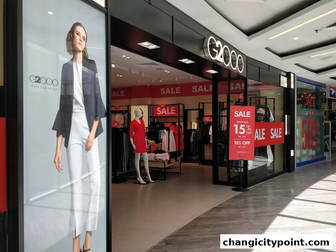 G2000 shop front with sale signs and mannequins displaying clothing.