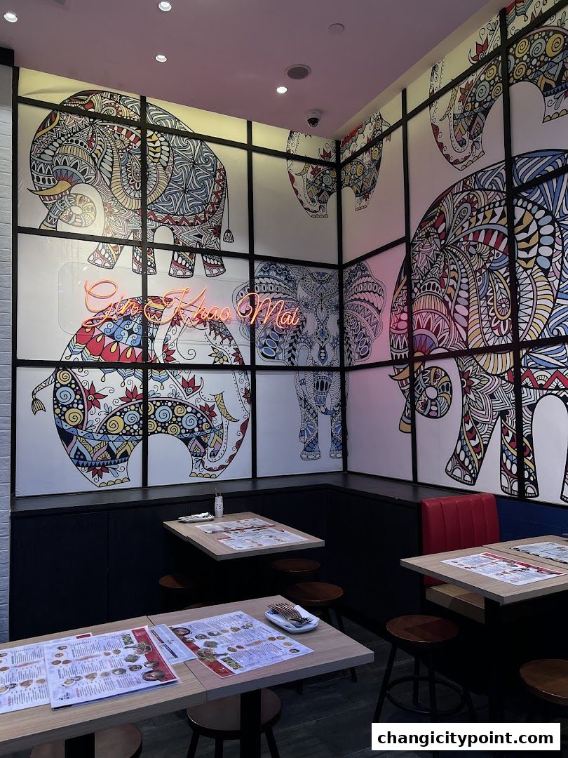 Interior of a restaurant with elephant-themed decor and tables set with menus.