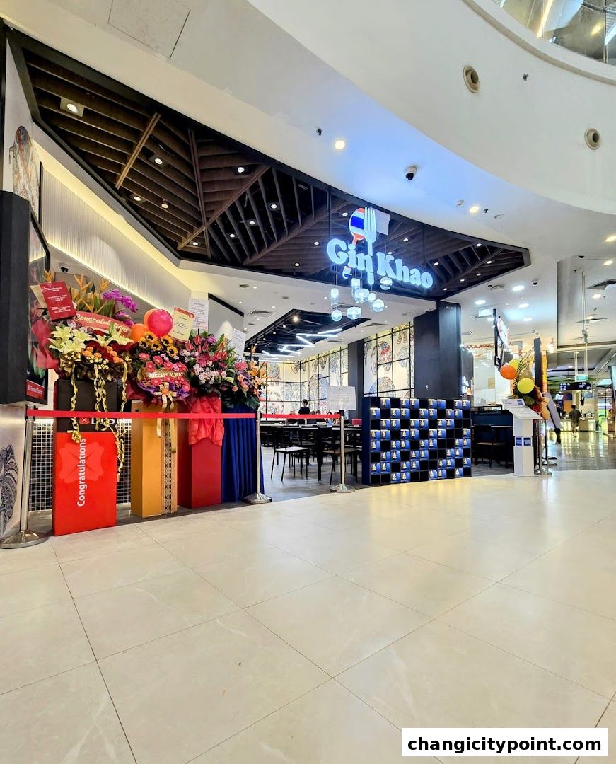 The entrance of Gin Khao restaurant decorated with congratulatory flower stands and balloons.