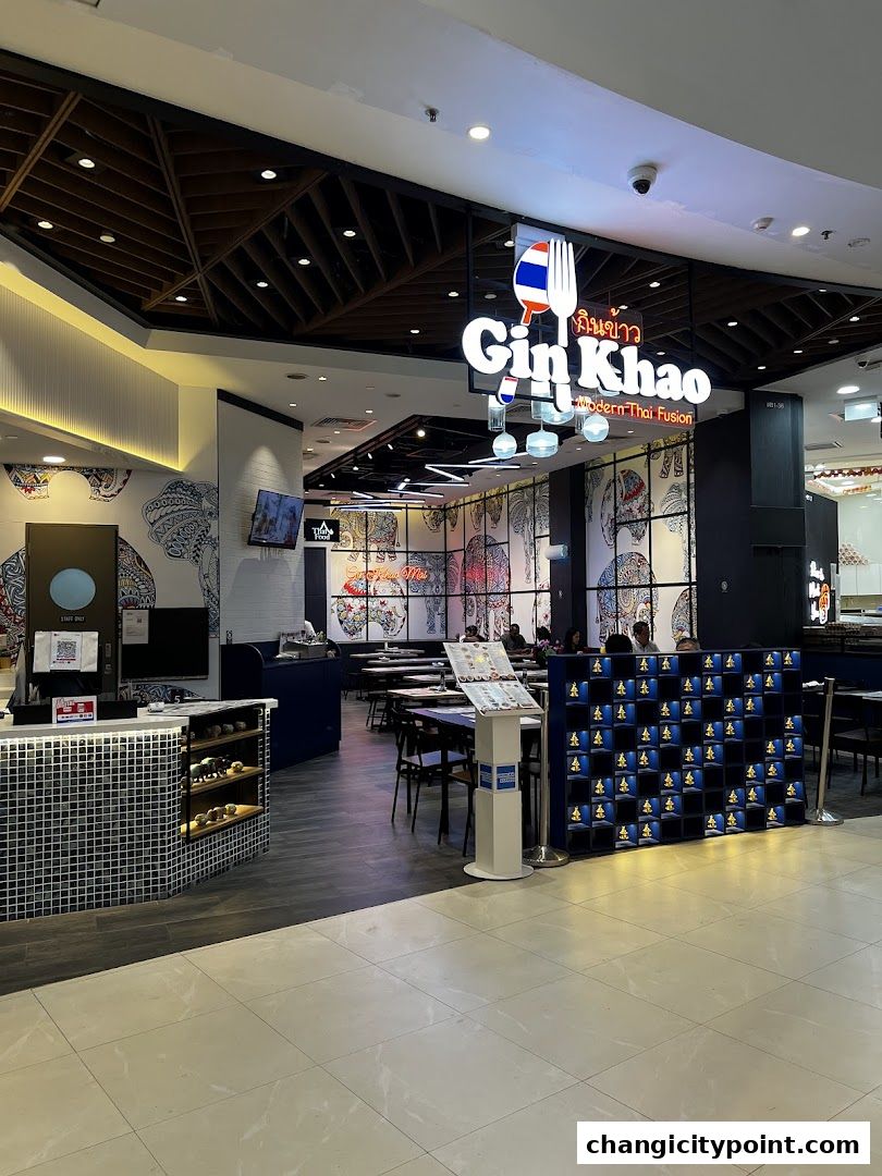 The exterior of Gin Khao, a modern Thai fusion restaurant, with seating visible inside.