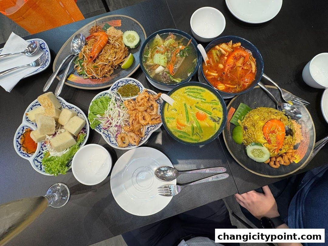 A spread of delicious Thai dishes including Pad Thai, curry, and fried calamari.