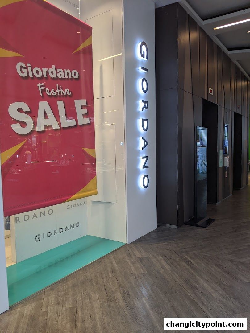 Giordano shop entrance with a festive sale banner and illuminated signage.