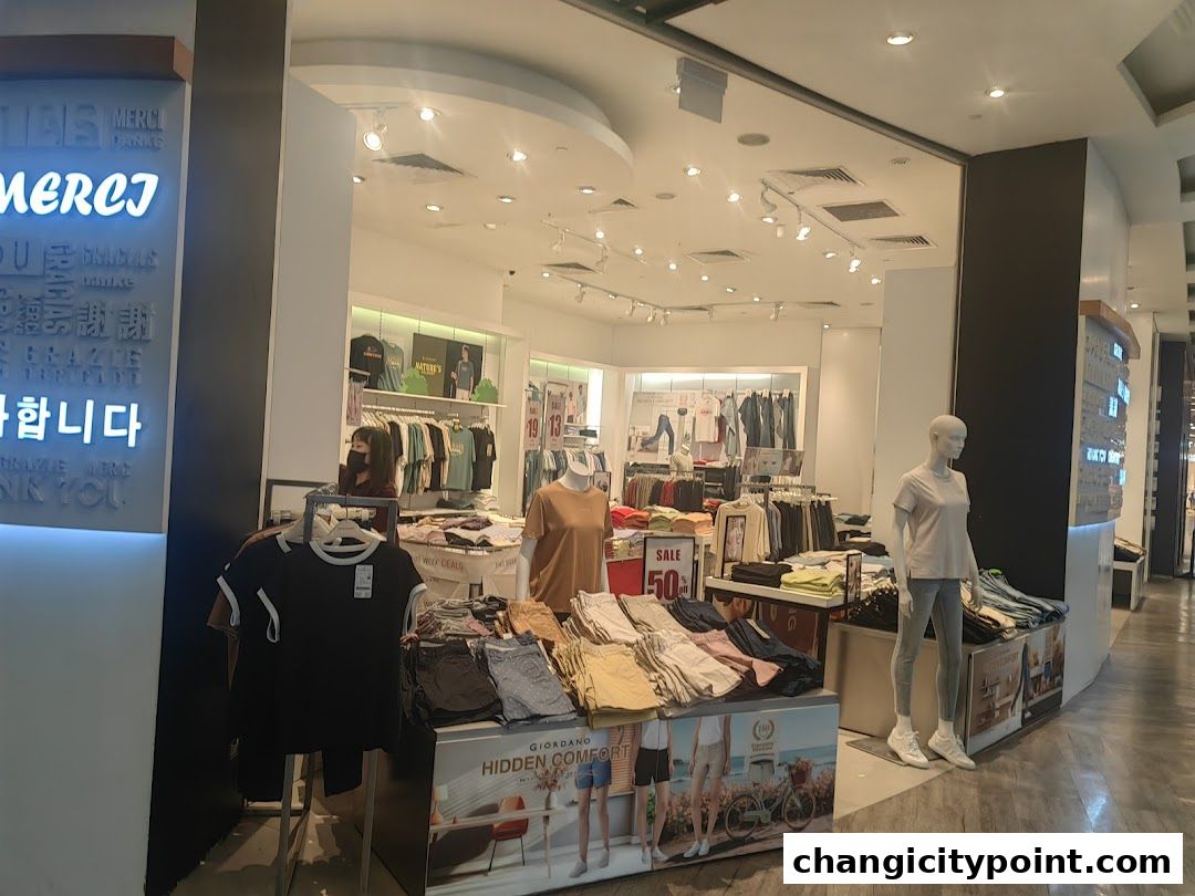 Interior view of a Giordano clothing store with mannequins and apparel on display.