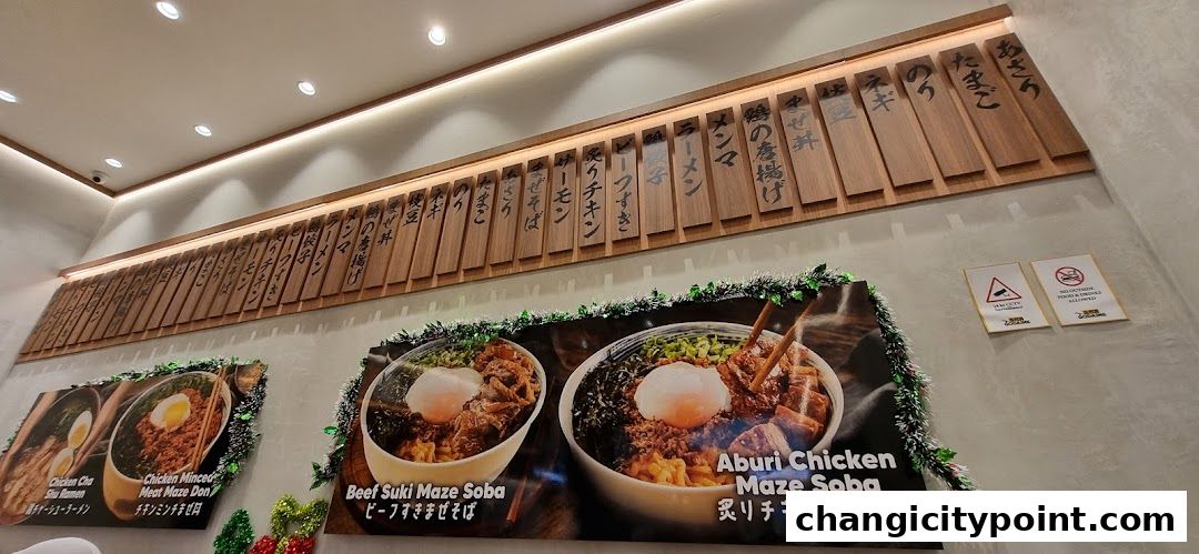 A wall display featuring Japanese food items and menu boards with Japanese text.