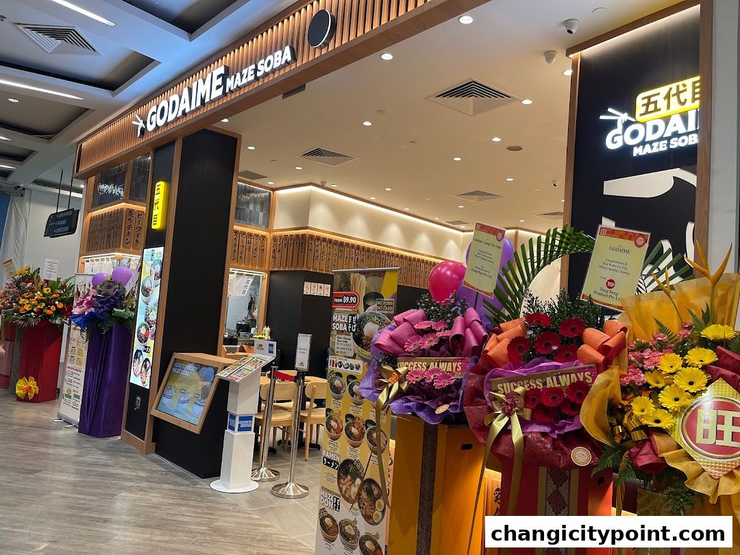 The exterior of a Japanese restaurant, Godaime Maze Soba, decorated with congratulatory flower stands.