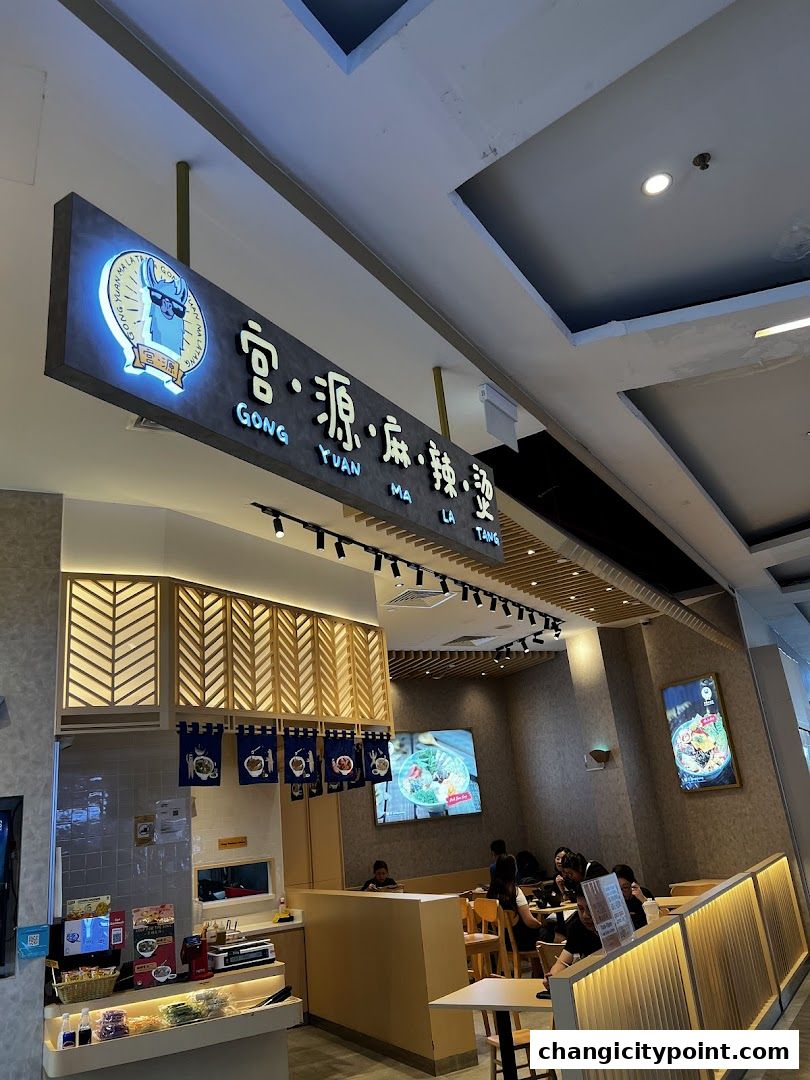 Interior view of Gong Yuan Ma La Tang restaurant with signage and dining area.