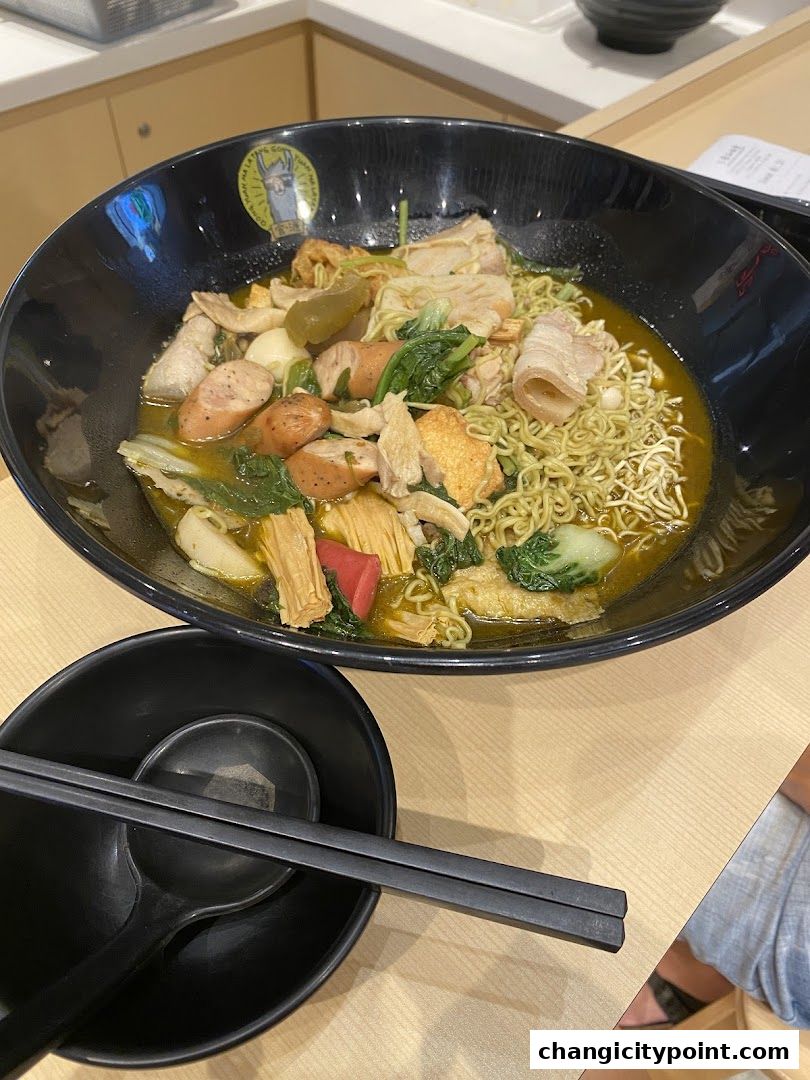 A large bowl of Mala Tang with noodles, meat, vegetables, and sausages.