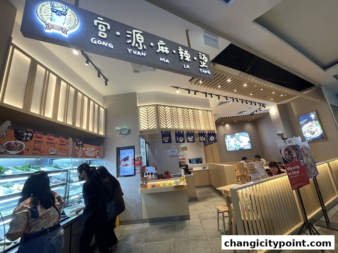 Interior view of Gong Yuan Ma La Tang restaurant with customers selecting ingredients.