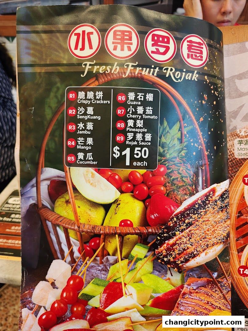 A menu featuring fresh fruit rojak with various fruits and dipping sauce.