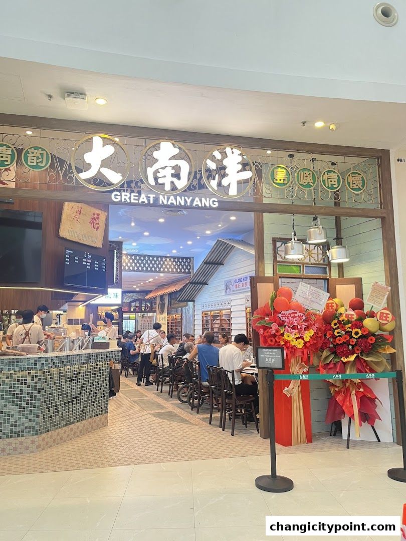The entrance of Great Nanyang Heritage Cafe with seating and decor.