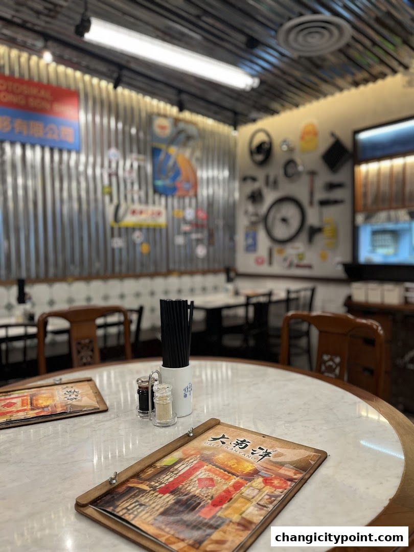 A table setting at Great Nanyang Heritage Cafe with menus and chopsticks.