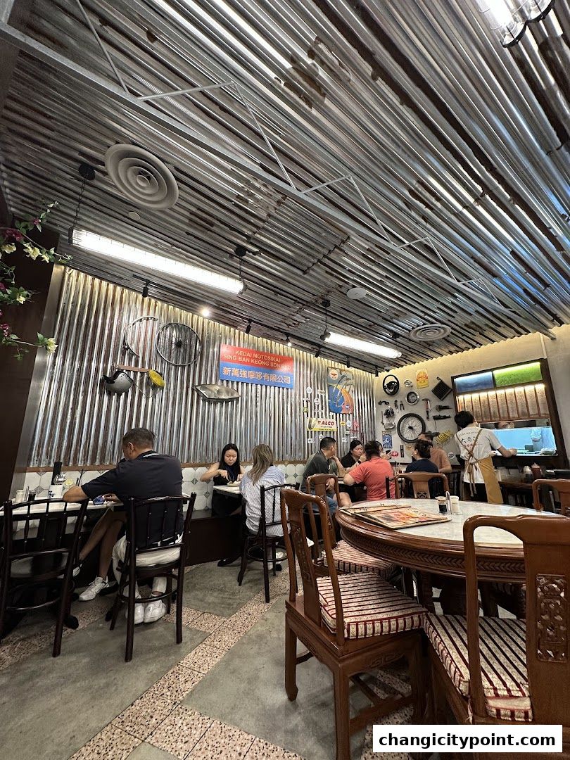 Interior of a cafe with patrons dining and vintage decor.