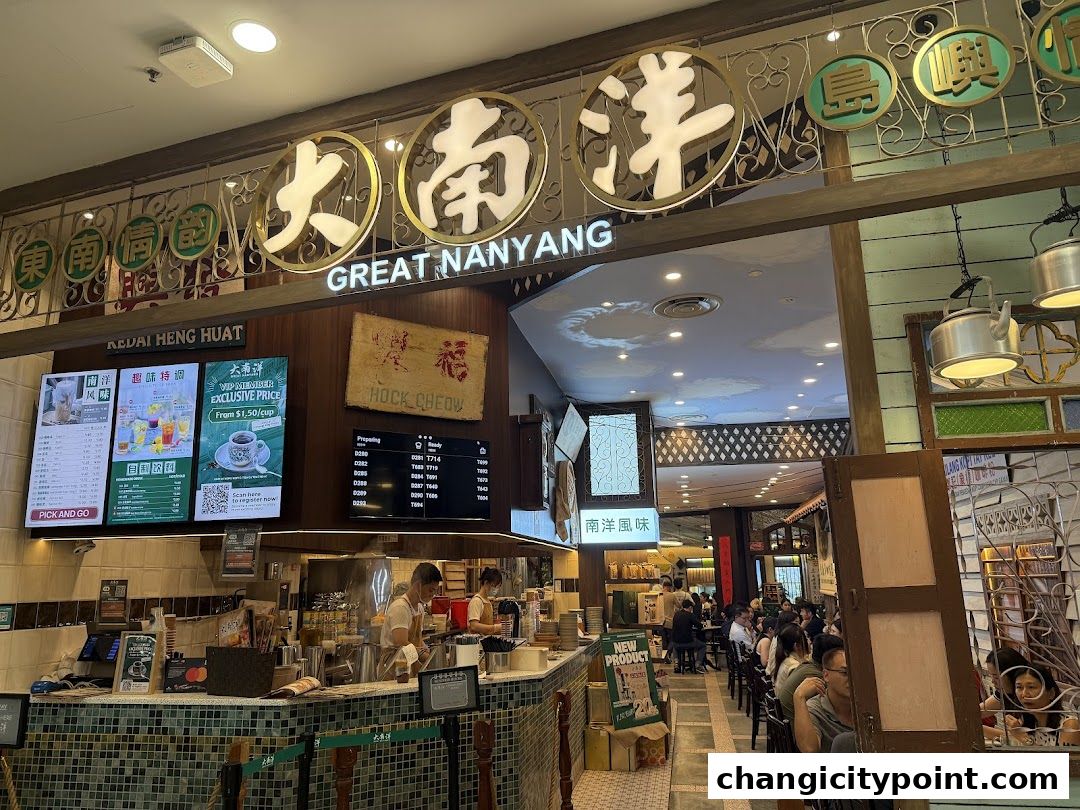 Interior of Great Nanyang Heritage Cafe with staff, seating, and menu displays.