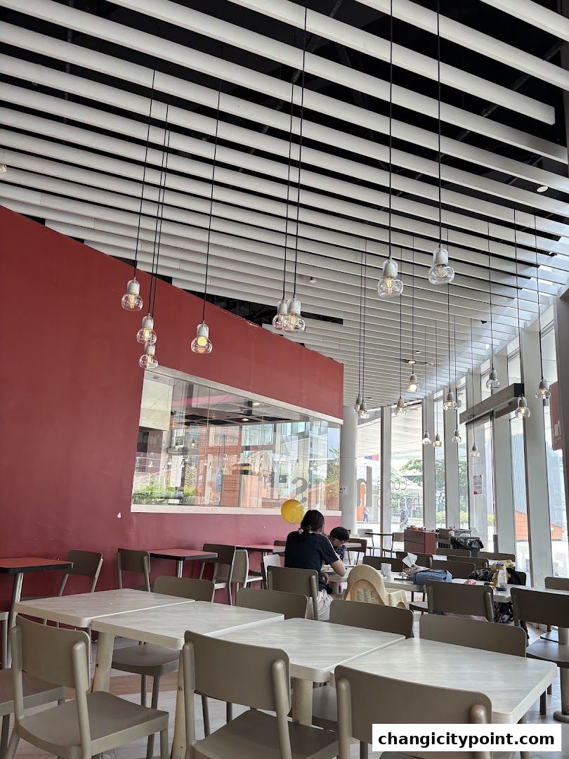 Interior of Hans Cafe Changi City Point with tables, chairs, and modern lighting.