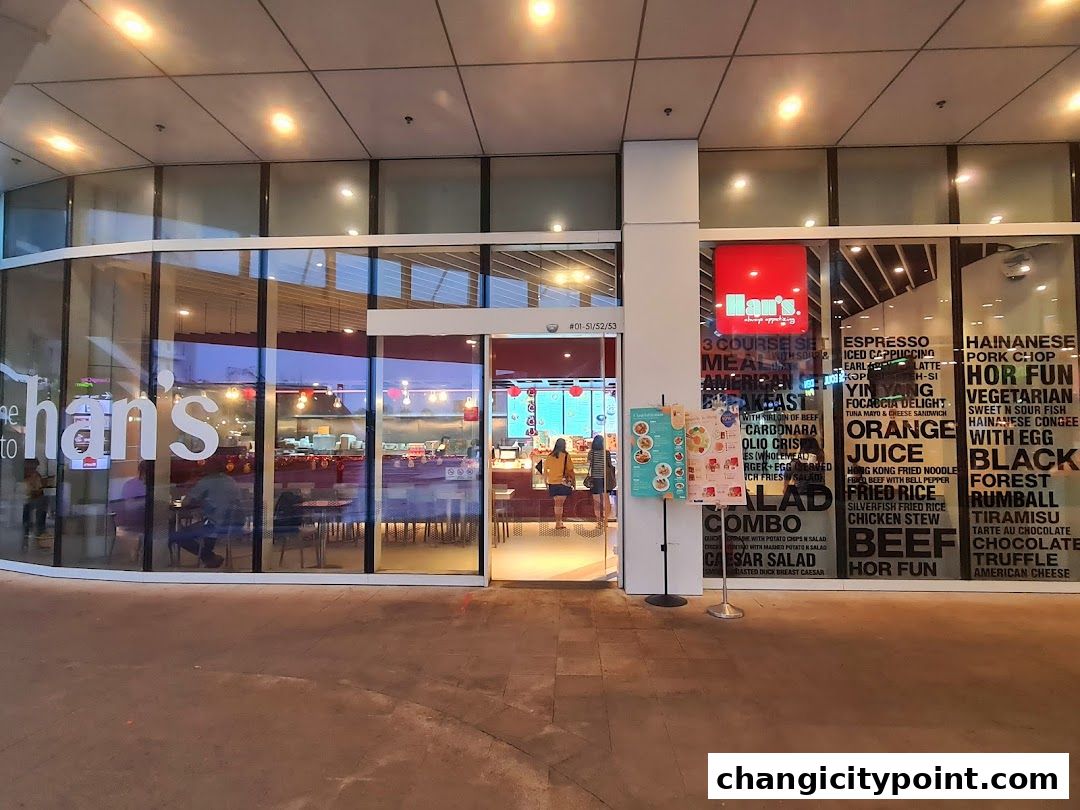 Exterior view of Hans Cafe Changi City Point with menu items displayed on the glass.