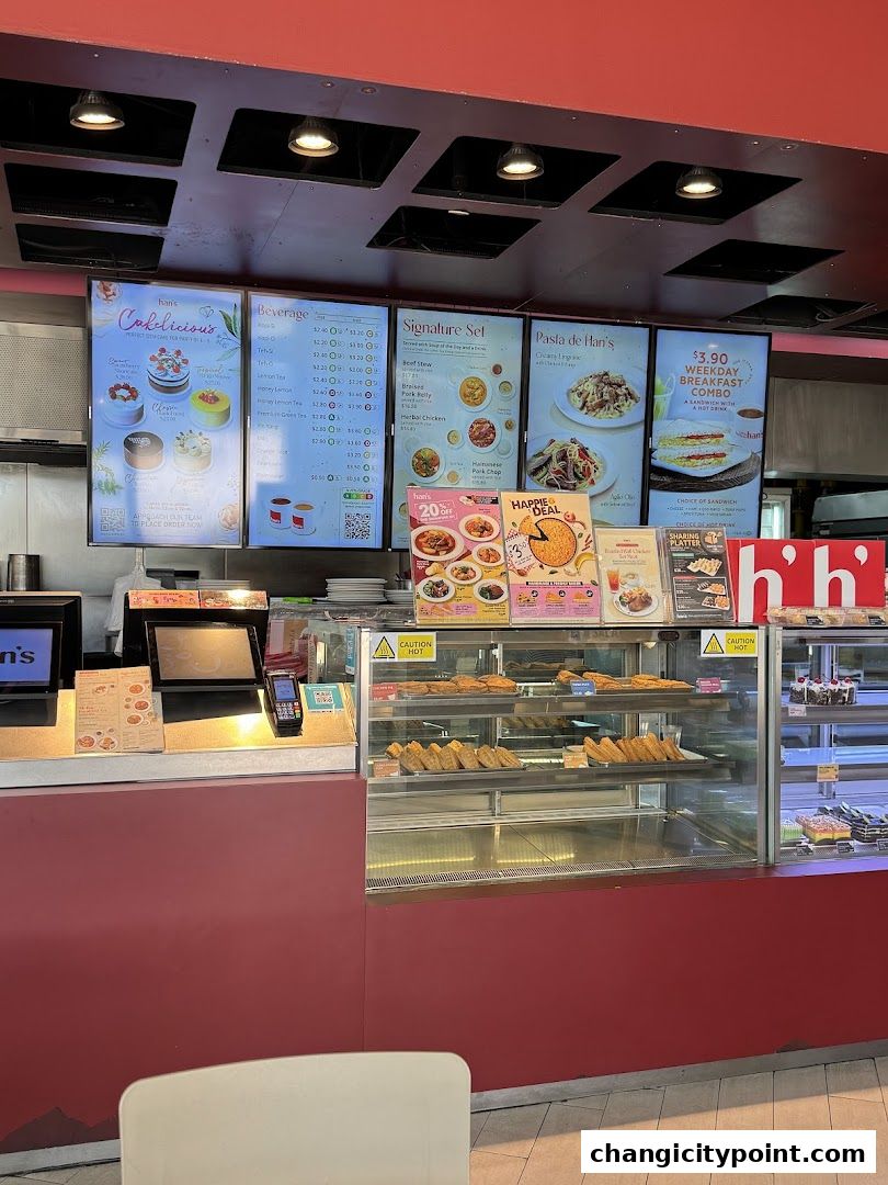 Digital menus display cakes, beverages, signature sets, pasta, and breakfast combos at Hans Cafe.