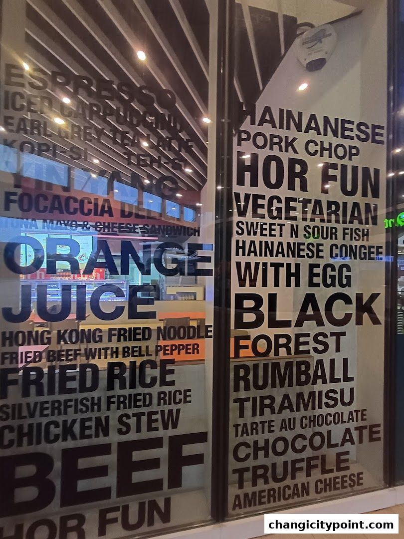 A glass storefront displaying a variety of food and drink menu items in large text.