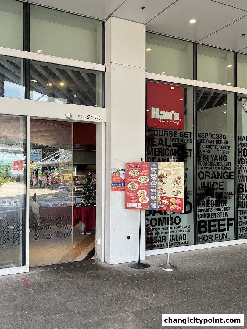 The exterior of Hans Cafe Changi City Point with a menu stand and visible interior.