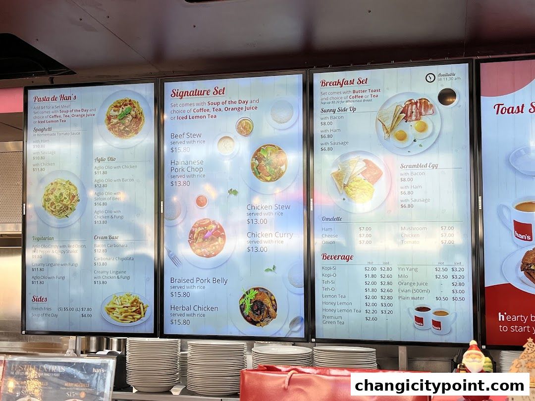 Digital menu boards displaying food and beverage options at Hans Cafe.
