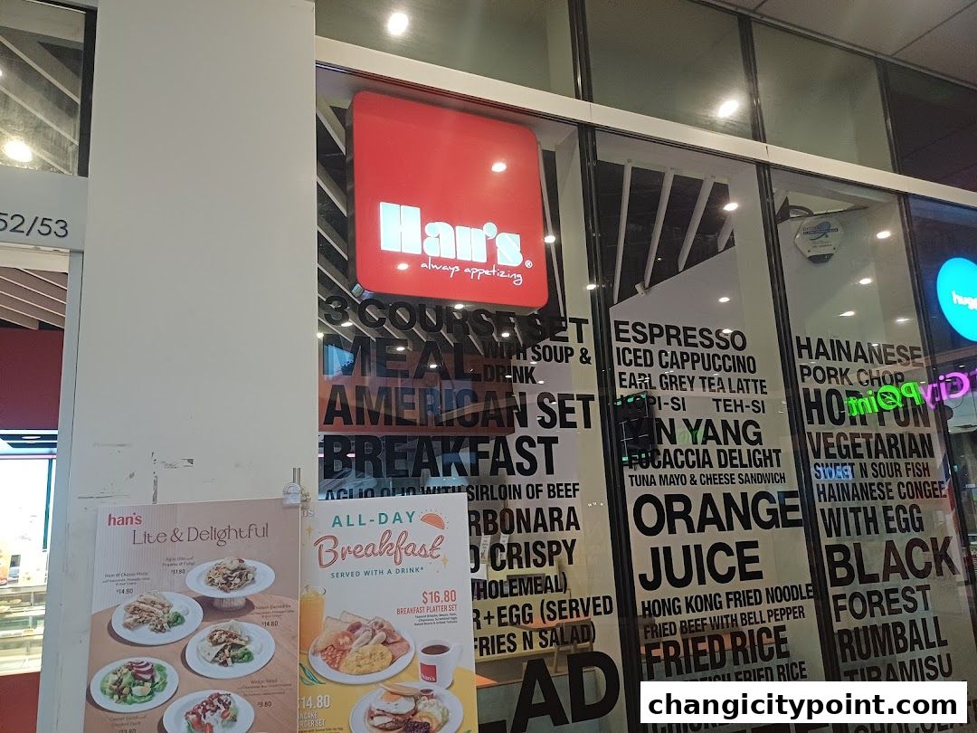 Exterior view of Hans Cafe Changi City Point with menu items displayed on the window.
