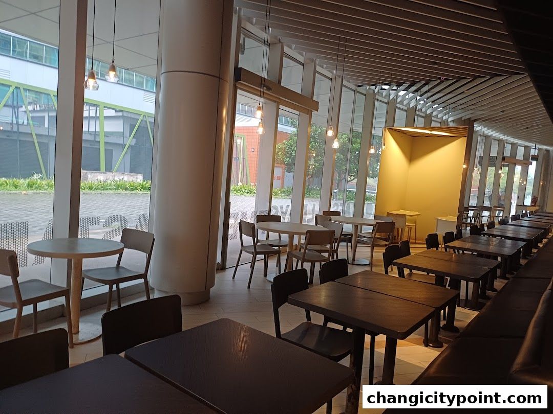 Interior view of Hans Cafe Changi City Point with tables and chairs.