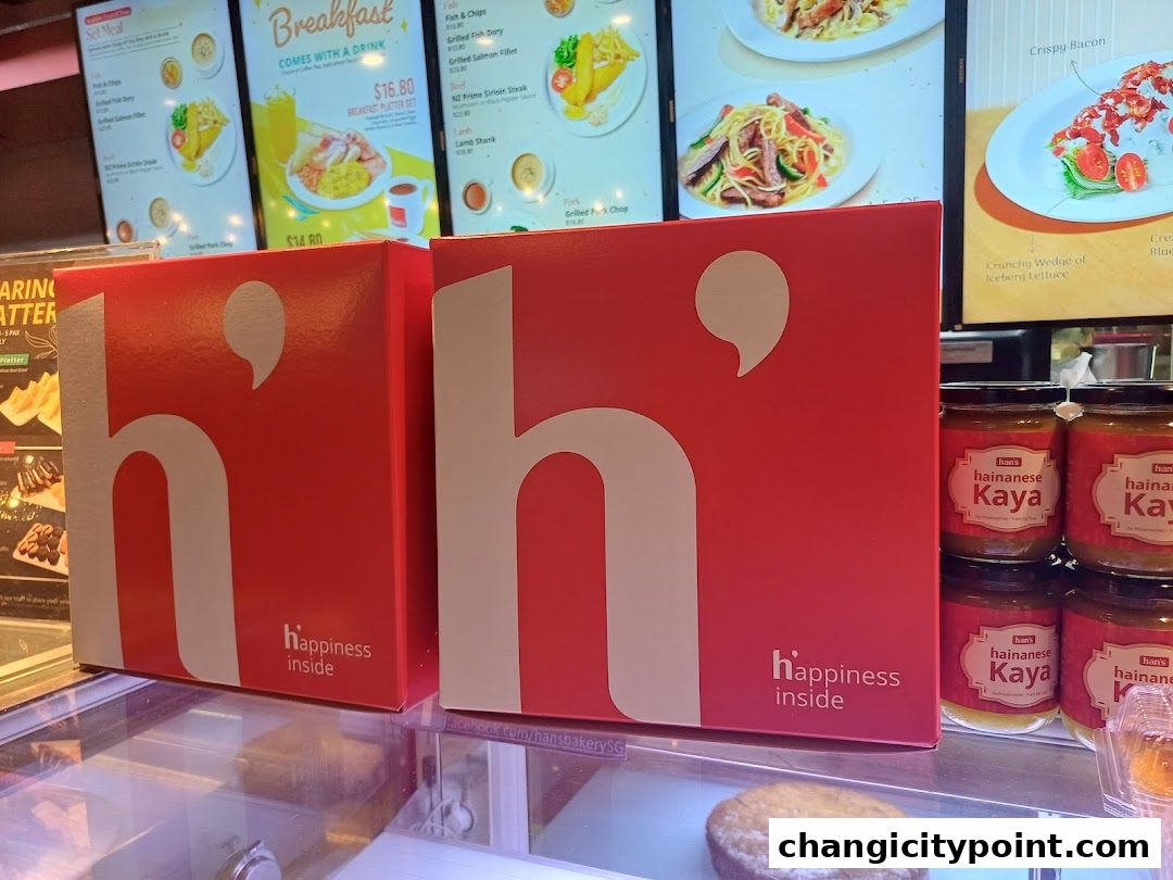 Red boxes with 'h happiness inside' logo and jars of kaya are displayed.