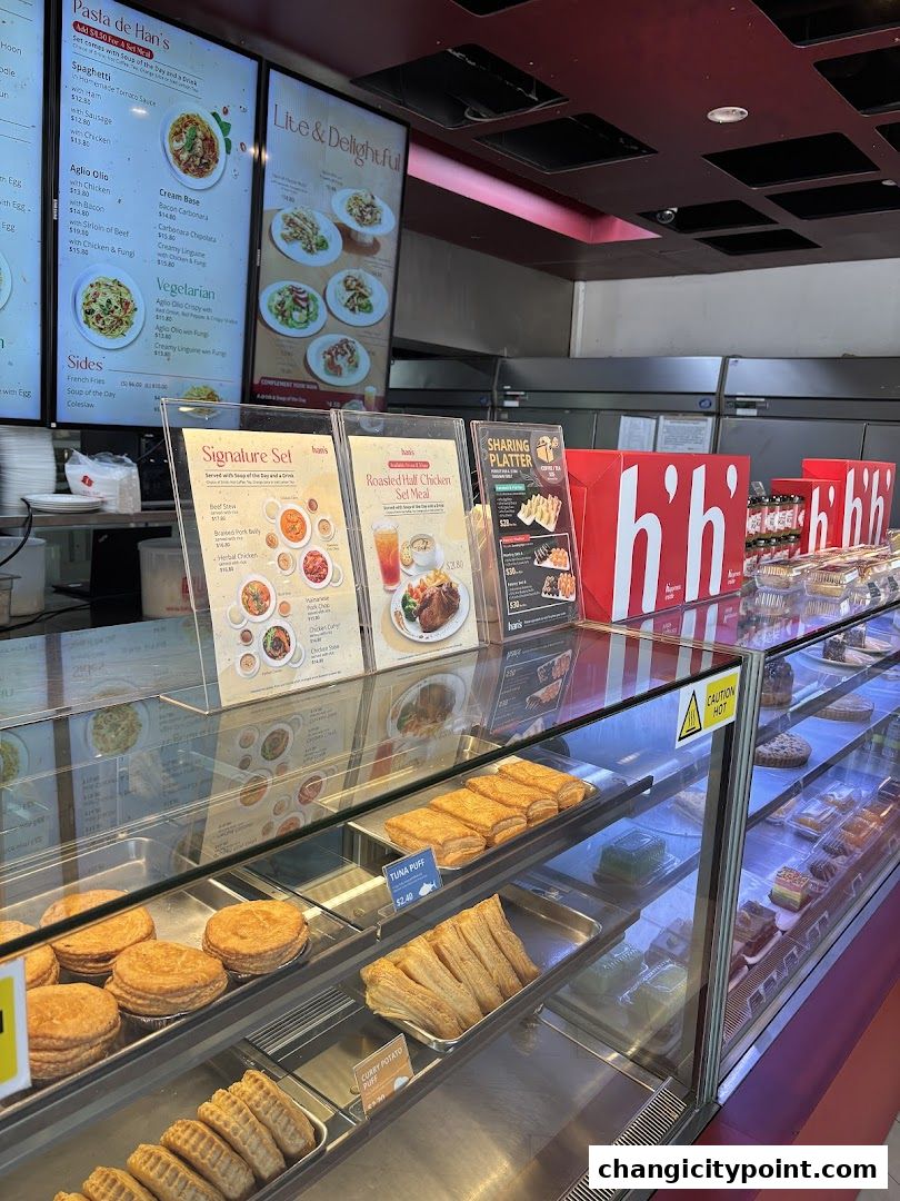 A display of food items and menus at Hans Cafe, Changi City Point.