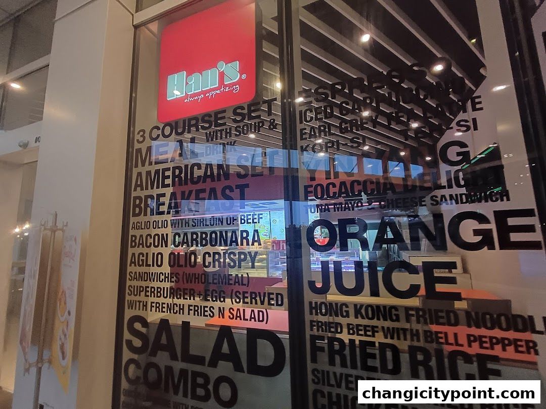 A shop window displaying a menu with various food and drink options.