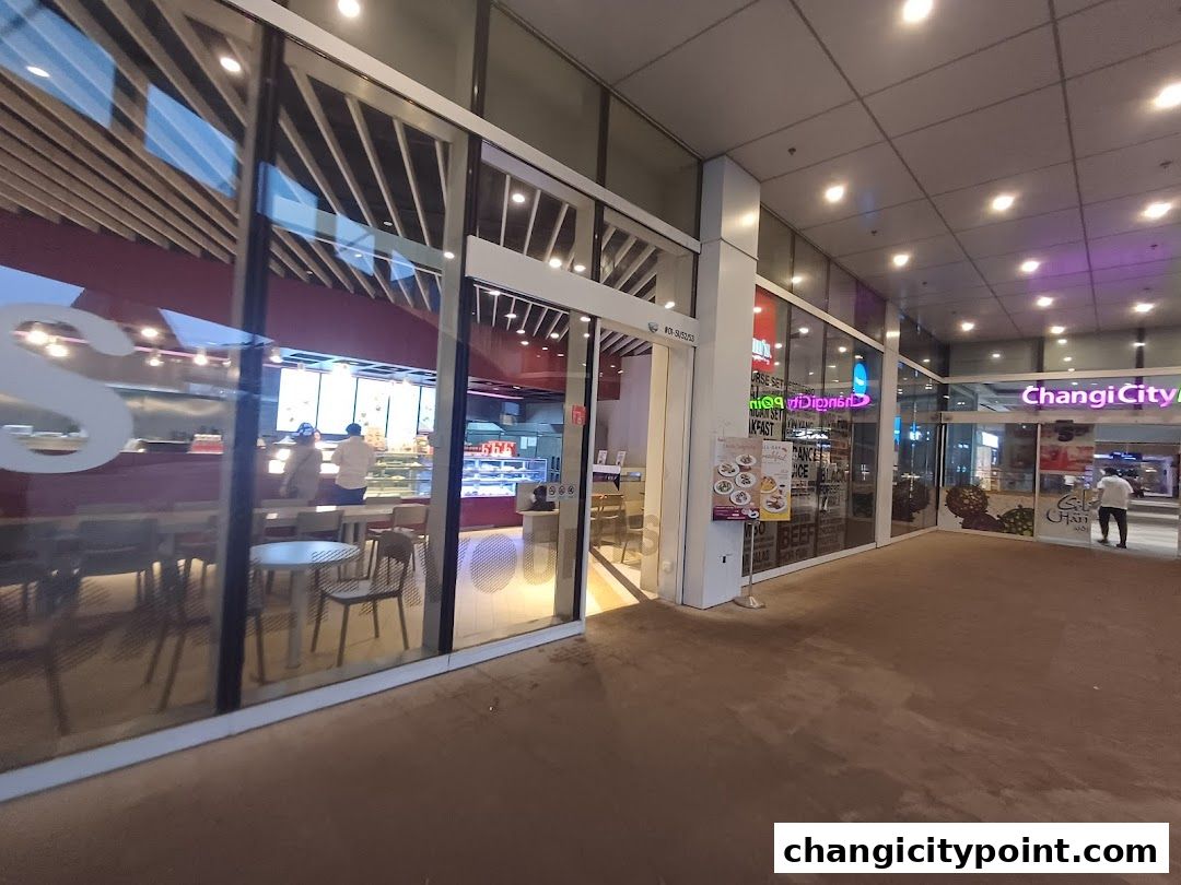 Exterior view of Hans Cafe Changi City Point with seating visible inside.