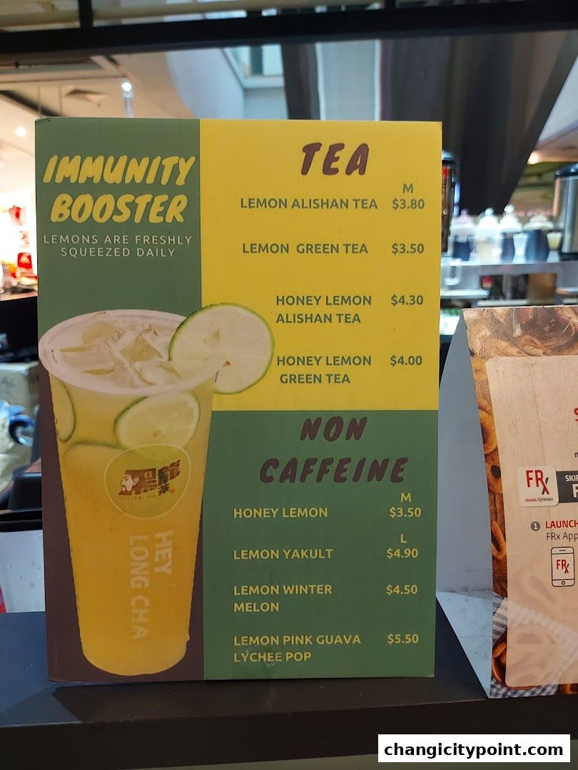 A menu board for Hey Long Cha featuring teas and non-caffeinated drinks with prices.