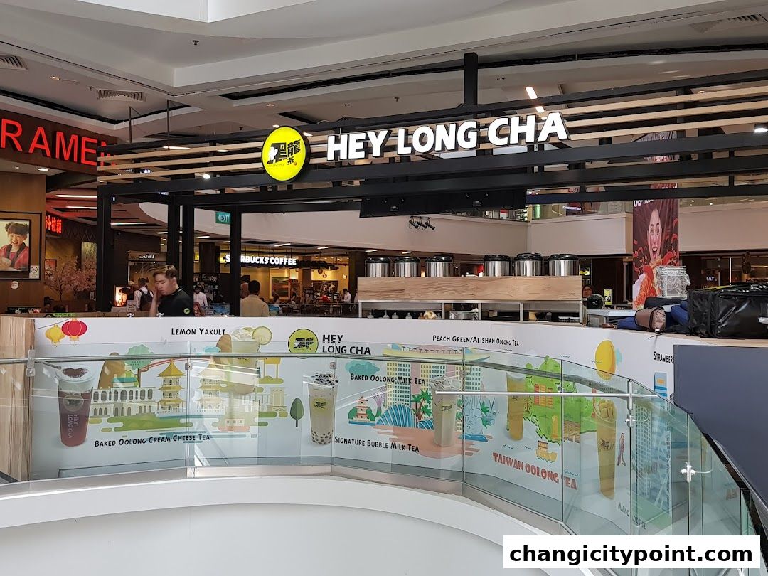 The exterior of the Hey Long Cha bubble tea shop with its prominent signage and colorful mural.