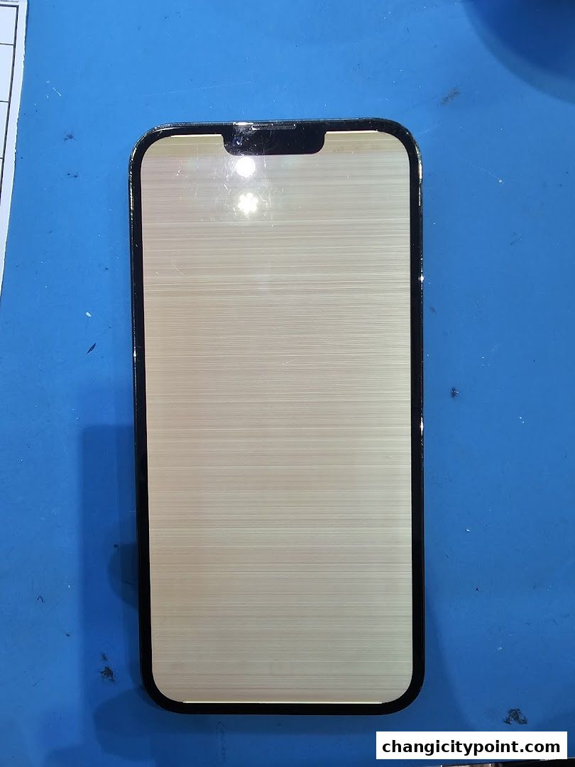 A damaged smartphone screen with horizontal lines displayed on a blue surface.