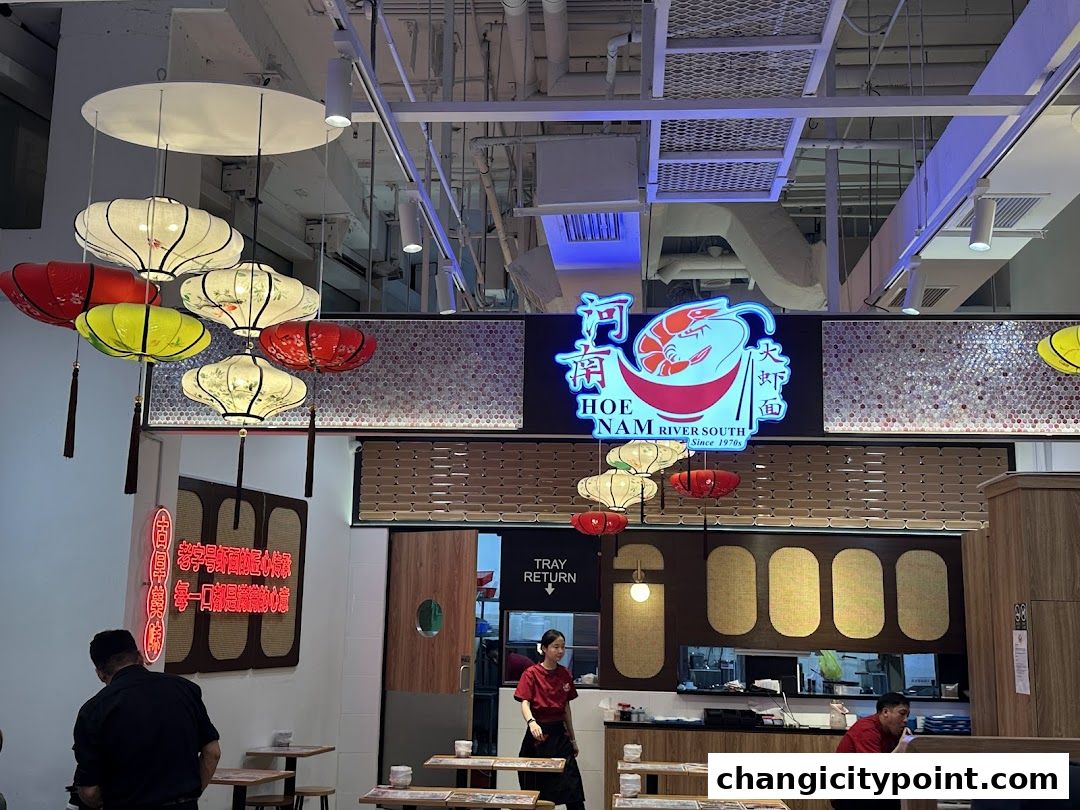 Interior of Hoe Nam River South Prawn Noodles restaurant with neon sign and lanterns.
