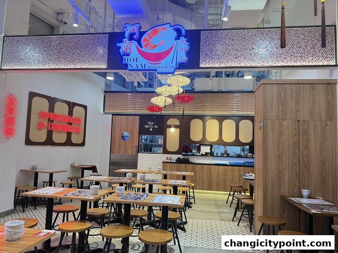 Interior of Hoe Nam River South Prawn Noodles restaurant with tables and chairs.