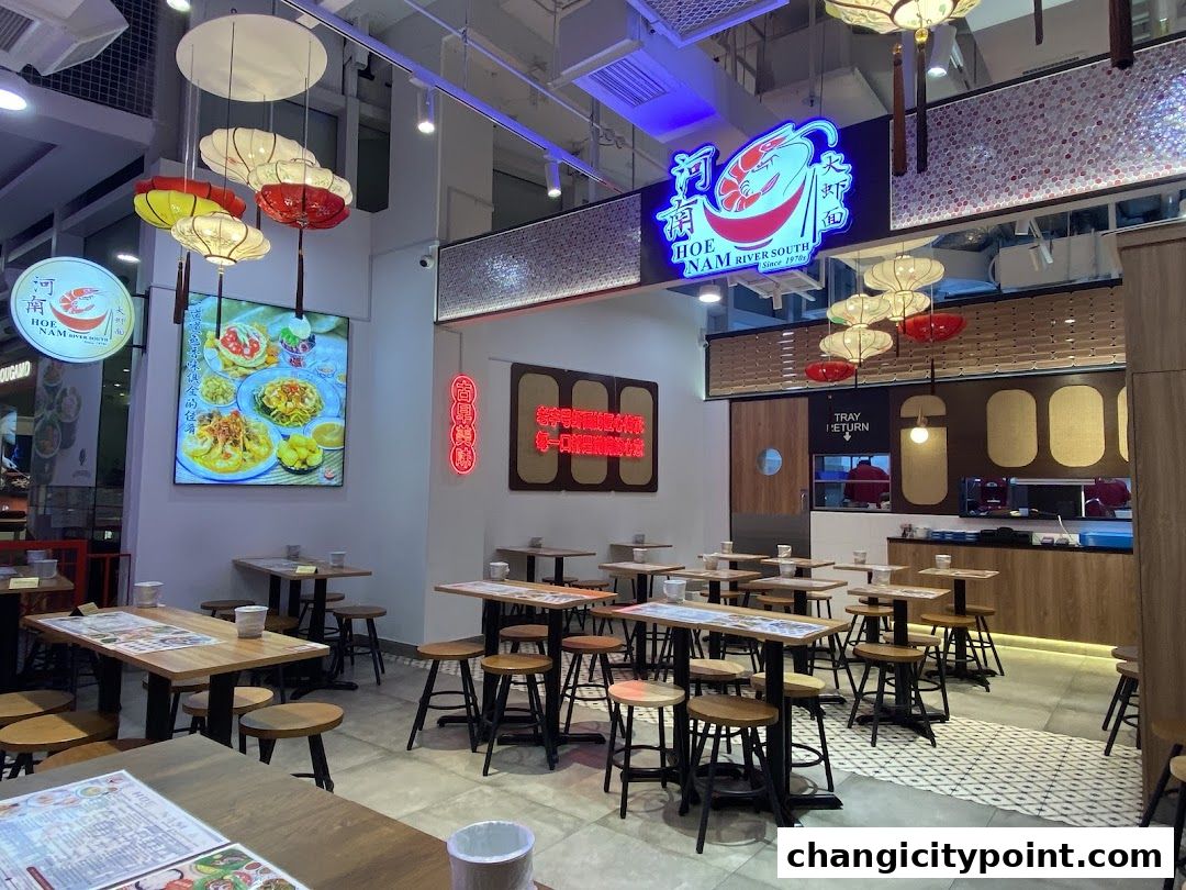 Interior of Hoe Nam River South Prawn Noodles restaurant with tables and chairs.