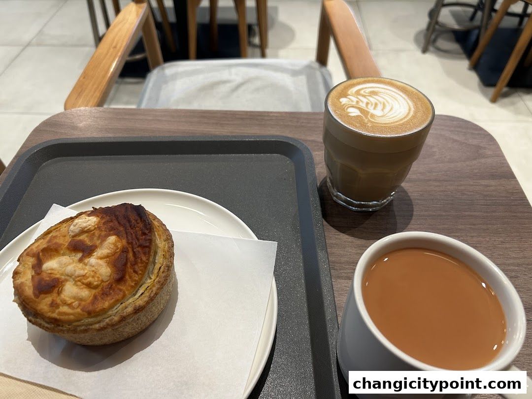 A pie and two coffees served on a tray at Huggs Coffee.