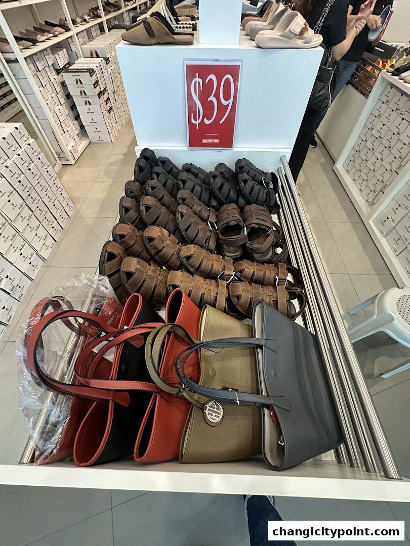 A display of Hush Puppies sandals and handbags with a $39 price tag.
