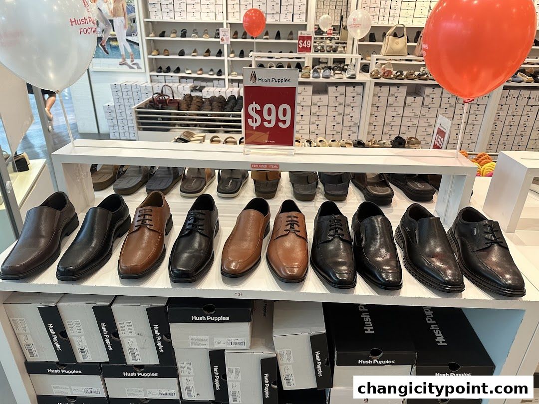 A display of men's dress shoes and shoe boxes at a Hush Puppies store.