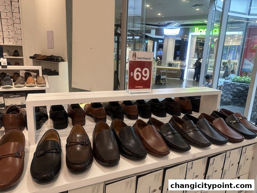 A display of various men's leather shoes at Hush Puppies, with a price tag of $69.