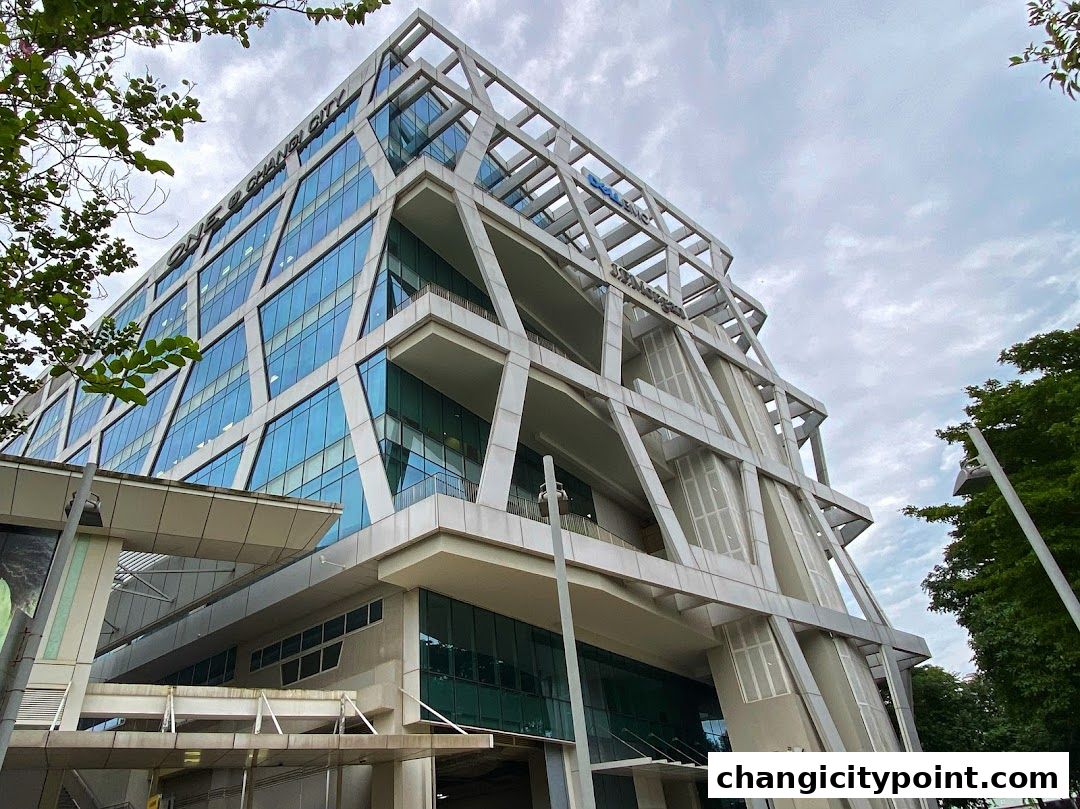 Modern office building with a unique geometric facade and glass windows.