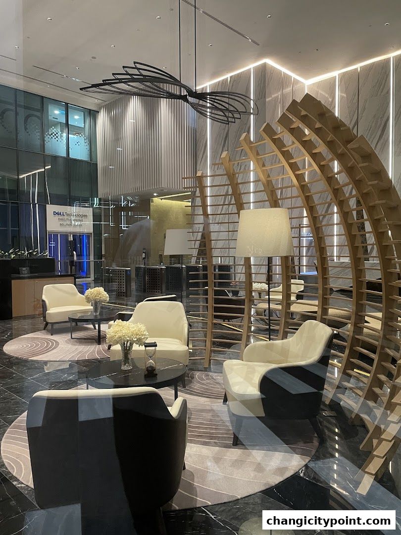Modern waiting area with stylish chairs, decorative screens, and ambient lighting.