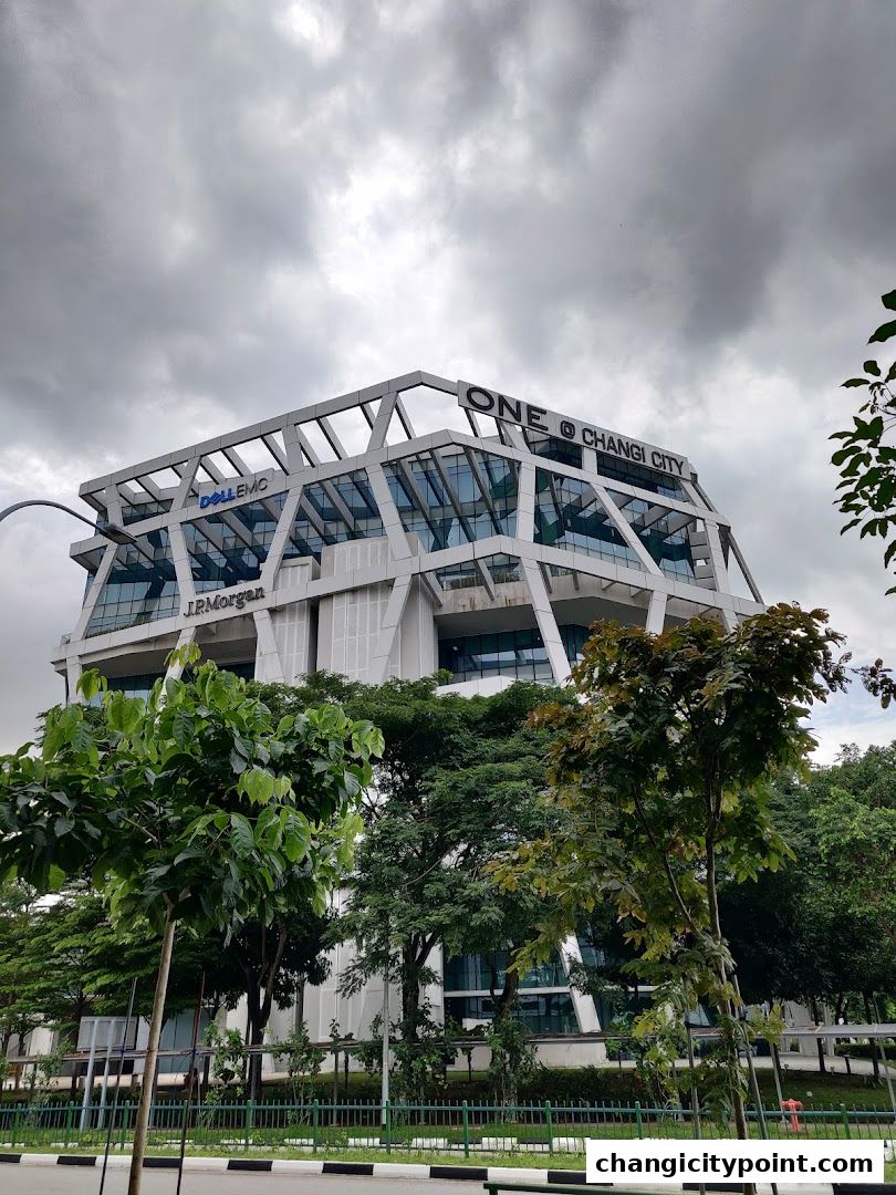 Modern office building with 'J.P. Morgan' and 'ONE @ CHANGI CITY' signage.