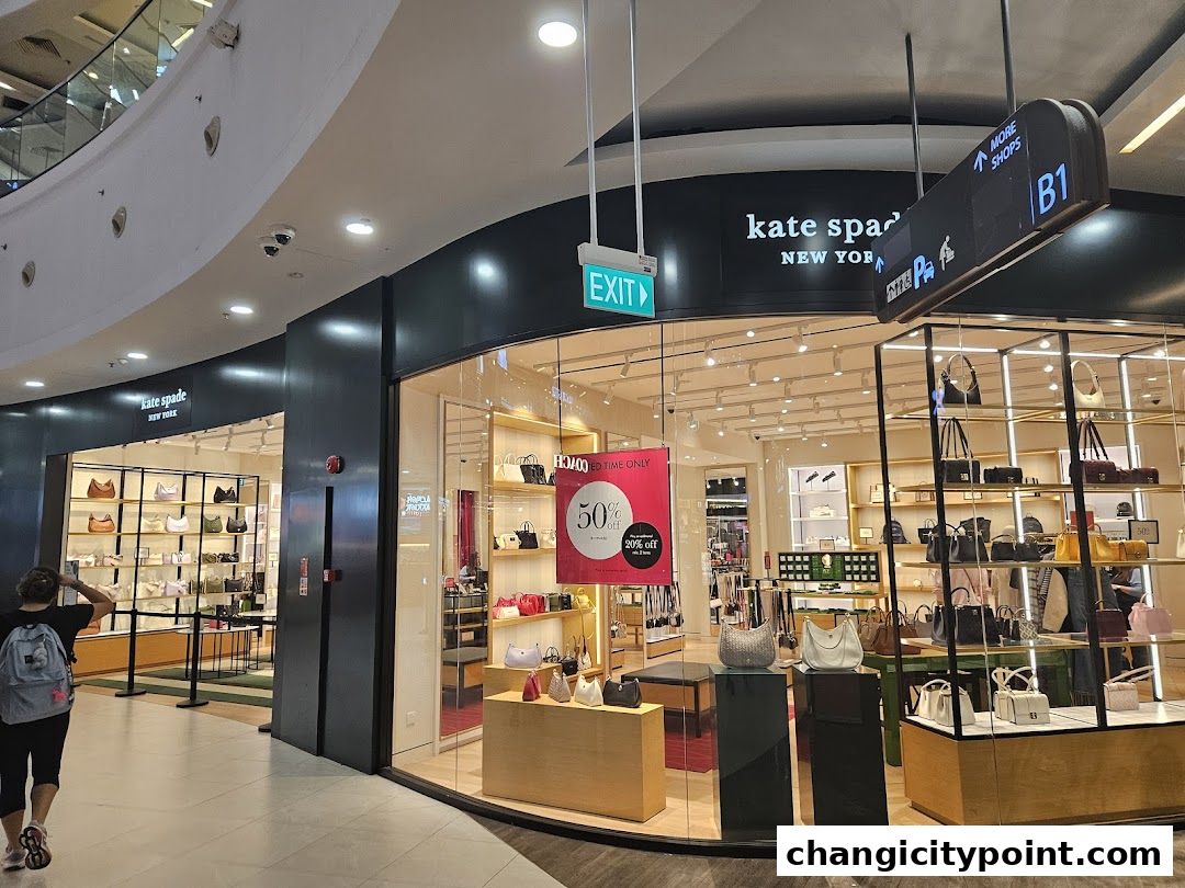The exterior of a Kate Spade New York store showcasing handbags and accessories.