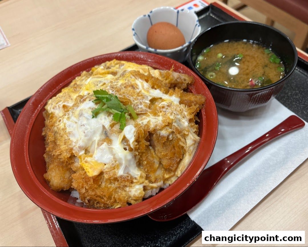 A delicious katsudon meal with miso soup and a boiled egg.