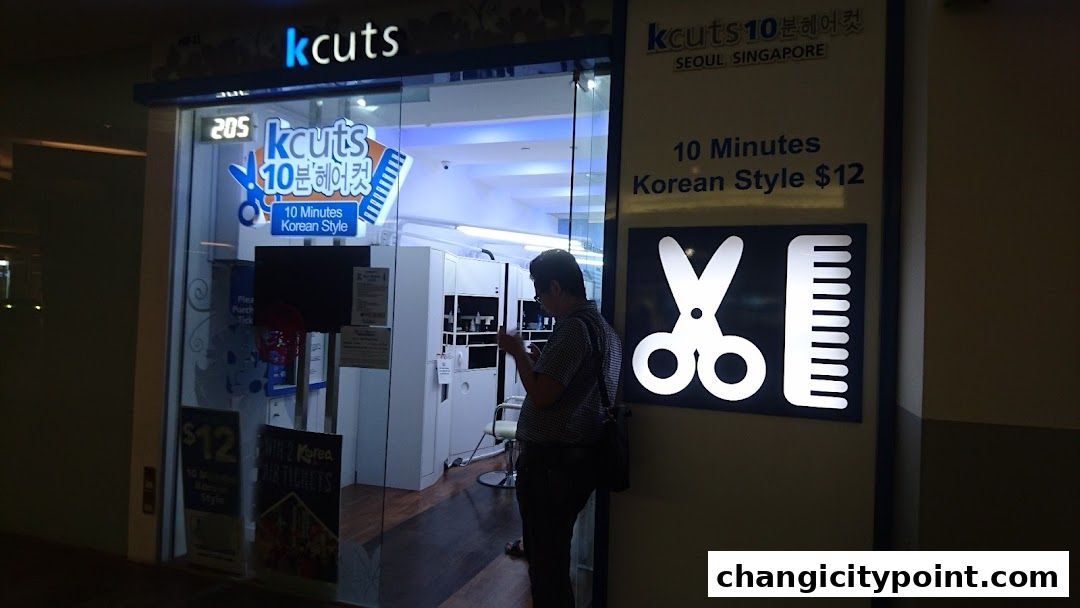 The exterior of a kcuts hair salon with a sign advertising 10-minute Korean style haircuts for $12.