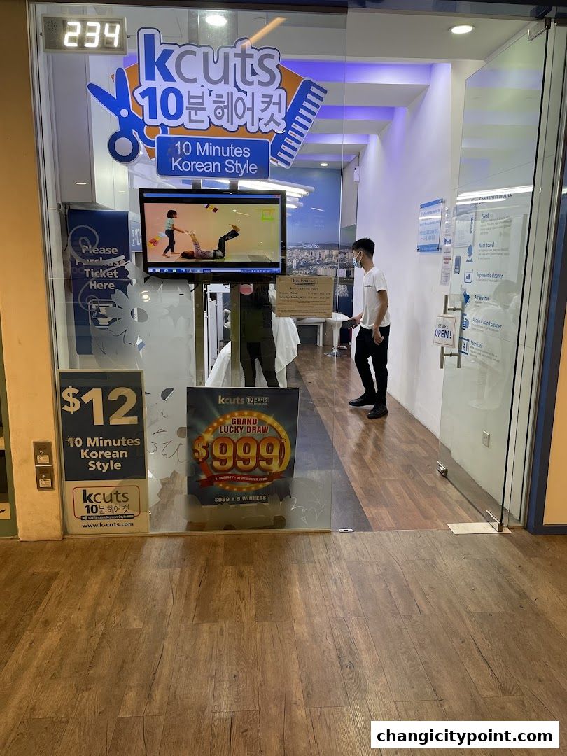 The entrance of kcuts, a 10-minute Korean style hair salon, with promotional displays.