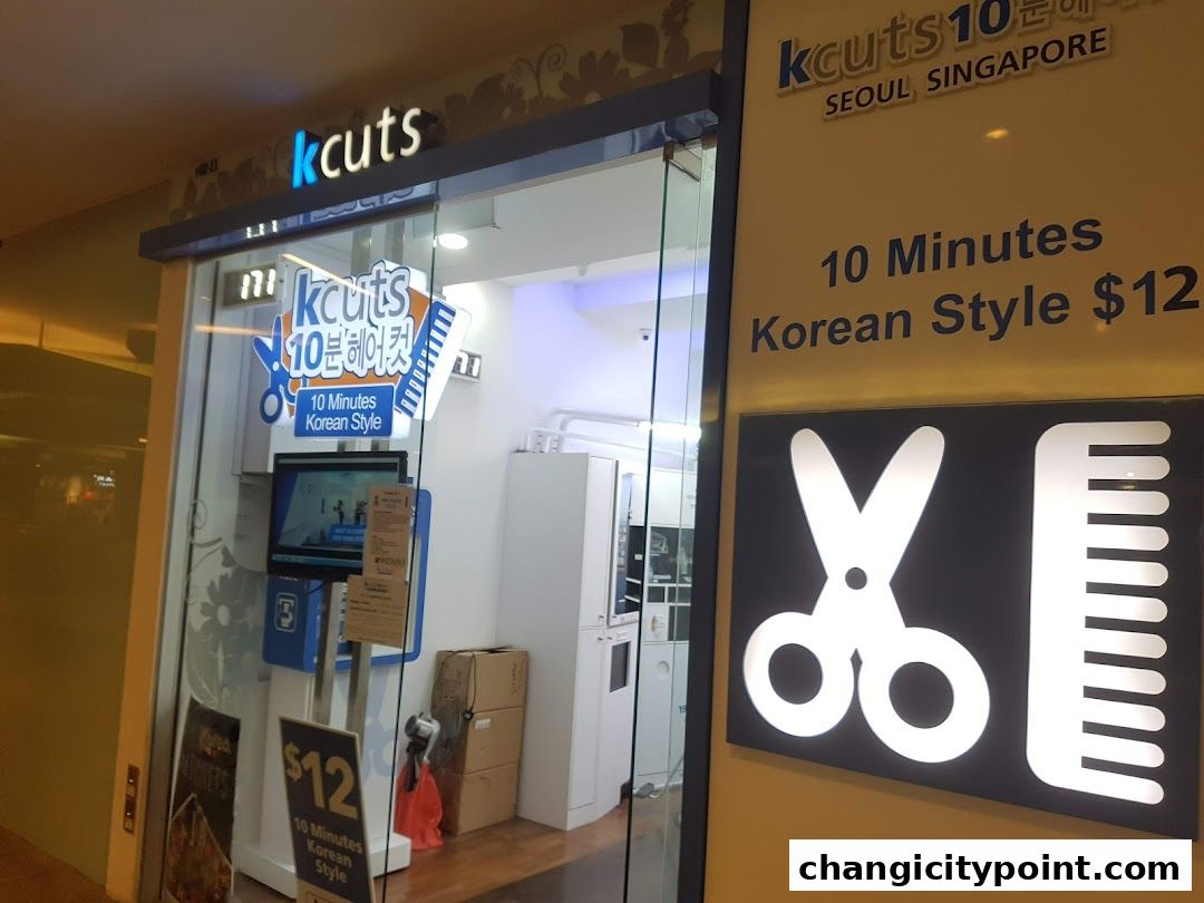 The exterior of a kcuts hair salon with signage advertising 10-minute Korean style haircuts.